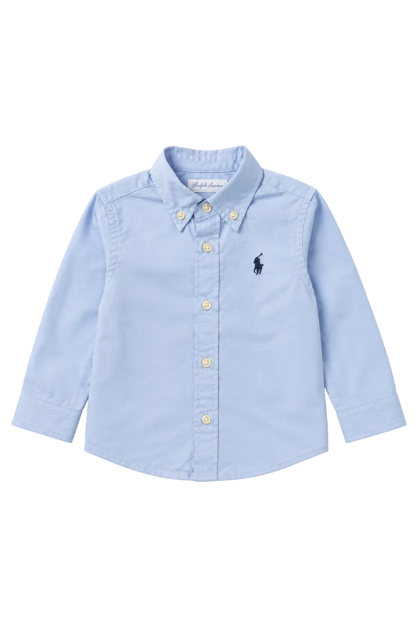Light blue button-up shirt with a small logo on a white background