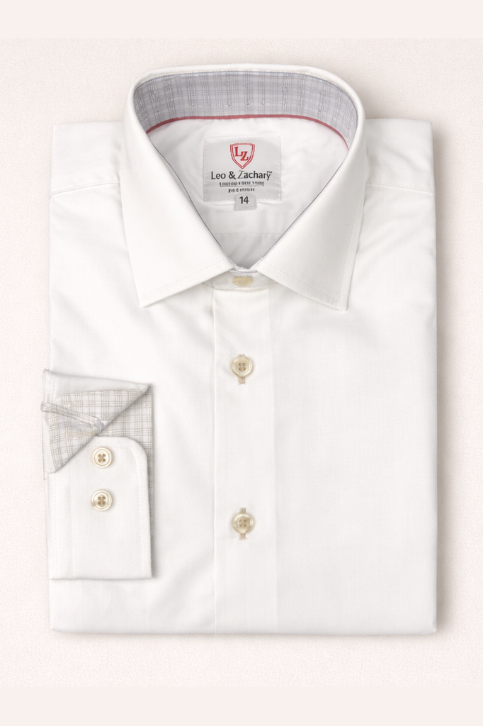Folded white dress shirt with a visible brand label on a light pink background