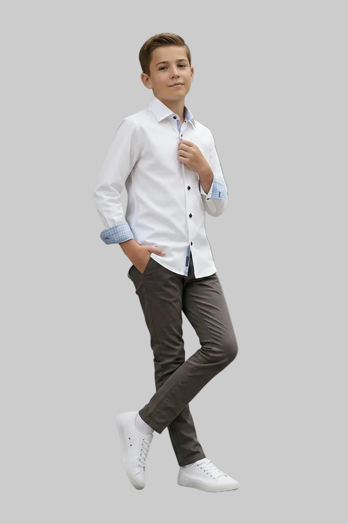 Young boy wearing a white shirt with rolled-up sleeves and brown pants on a gray background