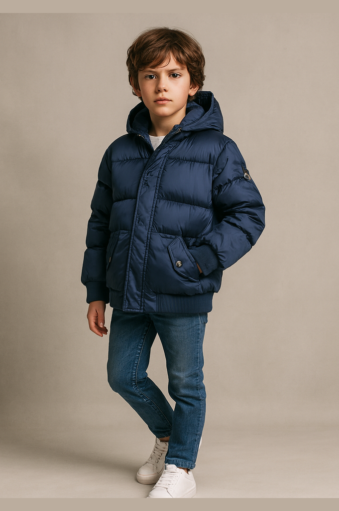 Child wearing a blue puffer jacket on a beige background