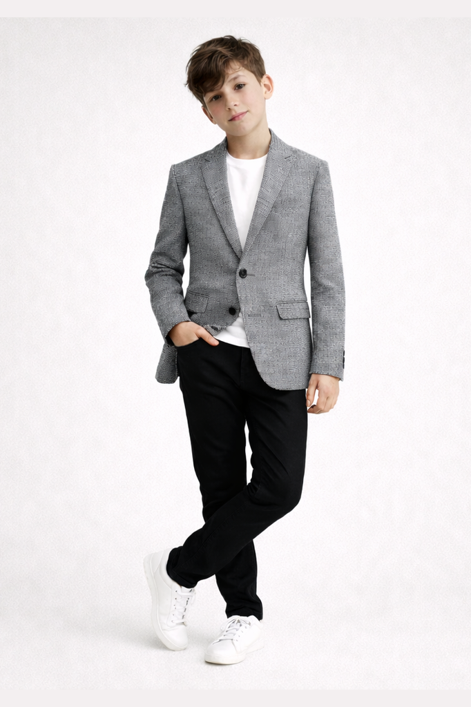 Person wearing a gray blazer, white shirt, black pants, and white sneakers on a white background