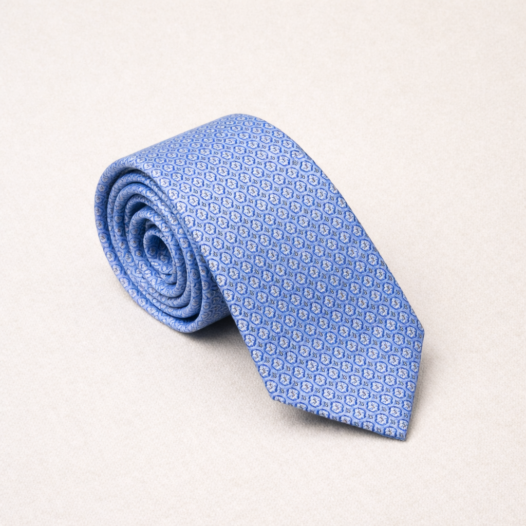 Rolled-up blue patterned tie on a light gray background