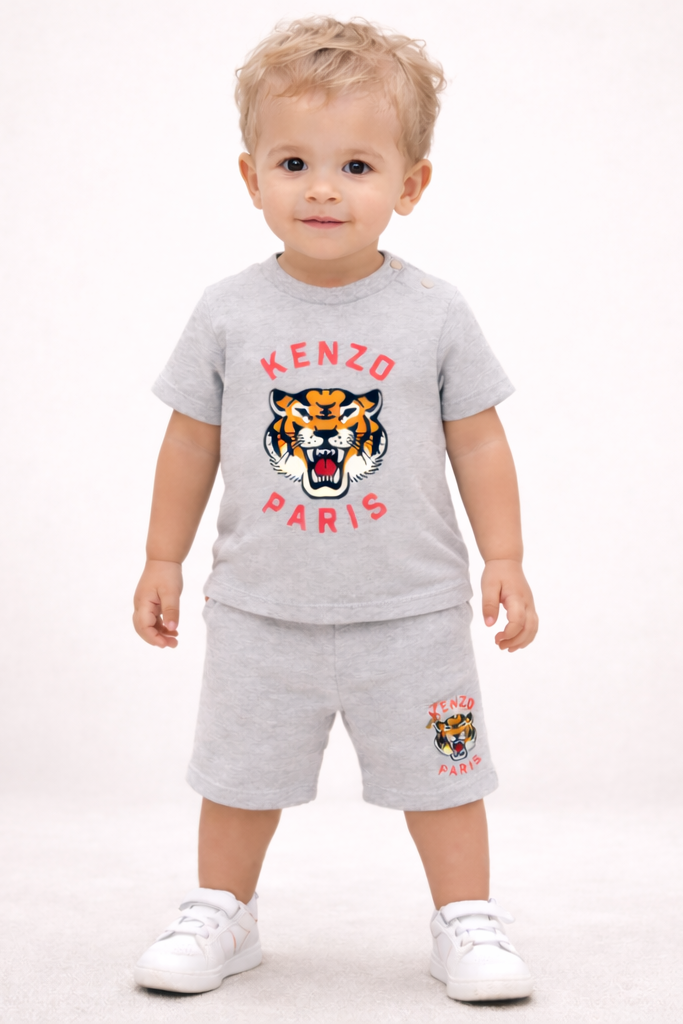 Child wearing a gray Kenzo Paris outfit with a tiger logo on a white background