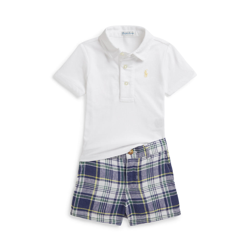 White polo shirt and blue plaid shorts set on a white background